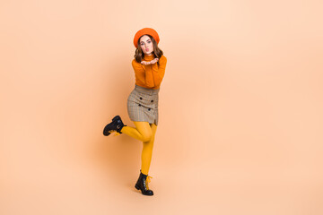 Sticker - Full length photo of adorable positive lady wear stylish orange clothes empty space sending kiss camera isolated on beige color background