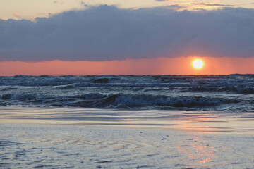 Wall Mural - Scenic sunset over the sea. Baltic sea after the rainy day. Poland seaside, Leba village and beach. Seascape