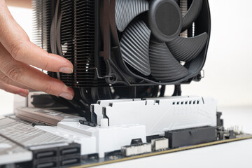 Poster - Installing a large air cooler on a computer processor.