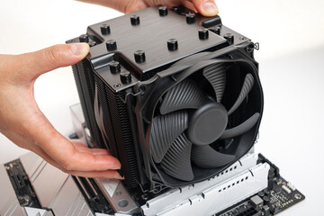 Poster - Installing a large air cooler on a computer processor.