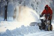Man in Red Jacket Clearing Snow with Manual Snowblower Equipment