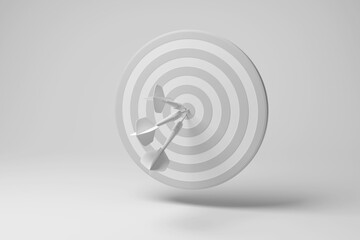 Three darts hit the bullseye of a dartboard floating in mid air on white background in monochrome and minimalism. Illustration of the concept of dart competition and business target market