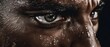 Extreme portrait close-up look of a professional black athlete with intense focus in his eyes and pouring sweat