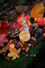 Wall Mural - Moon amulet, fruits, berries, fall leaves, crystal gemstones in forest, natural background. Wiccan altar for Mabon sabbat. autumn equinox holiday. Witchcraft, magic, esoteric spiritual ritual.