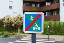 Road Sign - The End Of A Green Road In A Residential Area, Set In Front Of A Pedestrian Crossing.