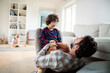 © Geber86 - Young father playing with his son in the living room at home