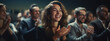 © MP Studio - Young Female Sitting in a Crowded Audience at a Conference and Applauding After Speech.
