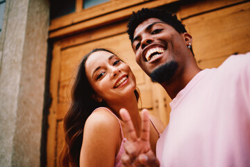 Young happy couple taking a selfie on the street