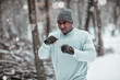 © Marko Geber - Young African American man shadowboxing and exercising in an outdoor park during winter and snow