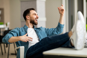 Aufkleber - Work With Fun. Cheerful Young Man Playing Virtual Guitar At Workplace