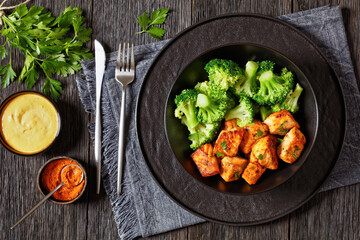 Wall Mural - baked salmon bites with steamed broccoli florets