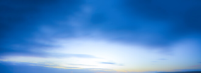 Wall Mural - blue blurry dark cloud sky background with sun light clouds