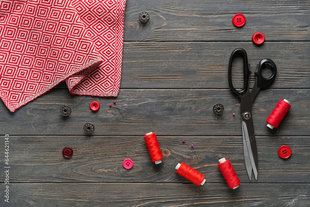 Composition with sewing supplies on dark wooden background