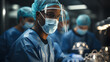 close up of male surgeon in protective clothing performing operation in operating room. healthcare and medical concept