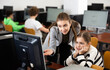 © JackF - Positive woman teacher together with the girl teaches how to work on the computer