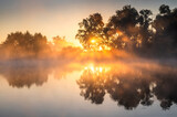 Fototapeta Na ścianę - Misty sunrise over calm lake