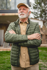 One senior man stand outdoor in front of his house happy confident