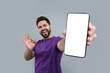 © New Africa - Young man showing smartphone in hand and OK gesture on light grey background