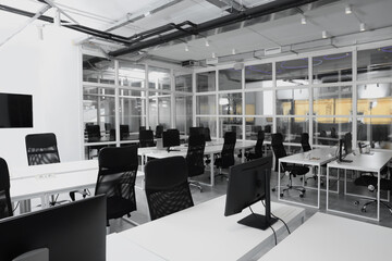 Wall Mural - Stylish interior of open plan office. Workspace with computers, tables and chairs