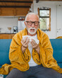 © Miljan Živković - one senior man sit on sofa bed hold Paper tissue common cold sneezing