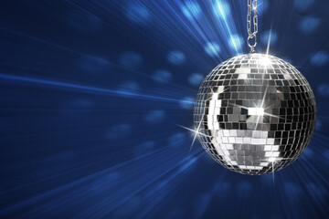 Poster - Shiny bright disco ball on blue background, space for text