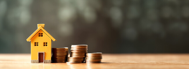 Economical Living: Tiny House and Coin Stack - Symbolizing Affordable Homeownership. 