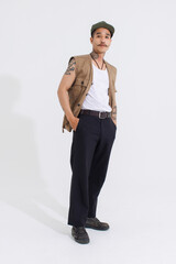 Portrait isolated cutout studio full body shot Asian vintage classy mustache neck arms tattoos male fashion model in casual fashionable safari vest and cap standing look at camera on white background