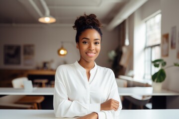 Smiling portrait of a happy young african american woman working for a startup company in an office