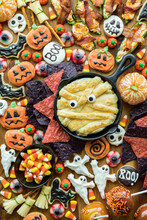 A Halloween Charcuterie Board With Cookies, Candy And Salty Snacks.