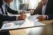 © yj - business executives discussing financial accounting documents report at meeting in office. generative AI