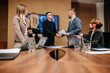 © Vladislav - In the meeting room, a team of general directors are talking, finalizing development, shaking hands. Stylish people in a modern conference room.
