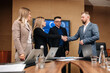 © Vladislav - In the meeting room, a team of general directors are talking, finalizing development, shaking hands. Stylish people in a modern conference room.