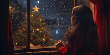Girl Looking Out Of Window At Christmas Tree At Night