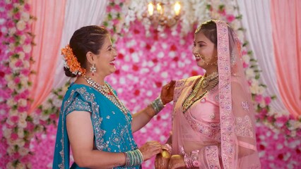 Wall Mural - Happy smiling mother with bridal daughter looking or posing to camera on wedding stage - concept of Joyful Moments, Family Love and Wedding Memories.