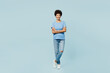 © ViDi Studio - Full body smiling fun young woman of African American ethnicity wear t-shirt casual clothes hold hands crossed folded look camera isolated on plain pastel light blue cyan background Lifestyle concept