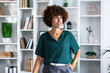 © Ivan - Portrait of a smiling young office worker standing alone in a modern office