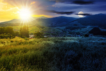 Wall Mural - mountainous summer landscape with sun and moon at twilight. village in the distant valley. day and n
