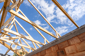 Wall Mural - Wooden roof with support joist, boards and timber planks against blue sky