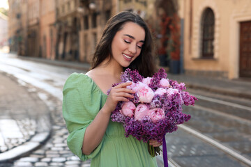 Poster - Beautiful woman with bouquet of spring flowers on city street