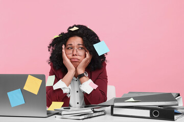 Poster - Stressful deadline. Exhausted woman sitting at white table against pink background. Sticky notes everywhere as reminders