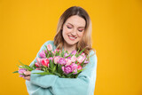 Fototapeta Tulipany - Happy young woman with bouquet of beautiful tulips on yellow background