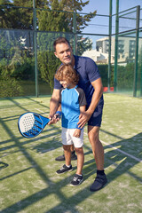 Wall Mural - Coach and boy exercising with racket