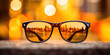 © red_orange_stock - Edge of black sunglass close up, orange, yellow bokeh background