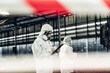 © kanpisut - Scientist wear Chemical protection suit check danger chemical, working at dangerous zone in Red and White Lines of barrier tape. Red and white Hazardous restricted area factory safety worker industry