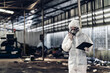 © kanpisut - Scientist wear Chemical protection suit check danger chemical, working at dangerous zone in Red and White Lines of barrier tape. Red and white Hazardous restricted area factory safety worker industry