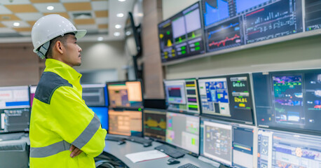 Wall Mural - Engineer working at control room,Manager control system,Technician man monitoring program from a lot of monitor