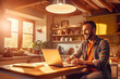 © JKLoma - happy man with tablet and laptop for remote work in kitchen of his home