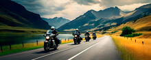 Motorcyclists Ride On A Winding Road Against The Backdrop Of Mountains