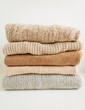 Women's knitted sweaters of beige colors. Winter, autumn, spring cozy clothes.
