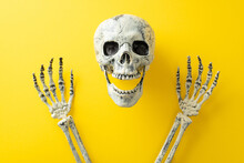 Step Into Realm Of Halloween Night's Chilling Ambiance. Top-view Perspective Capturing A Human Skull Screaming With Raised Hands On A Yellow Isolated Surface, Great For Text Or Advertising Integration